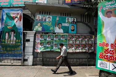 A man walks past the posters of Sajith Premadasa, Sri Lanka's presidential candidate of the New Democratic Front alliance, in Colombo, Sri Lanka. Reuters