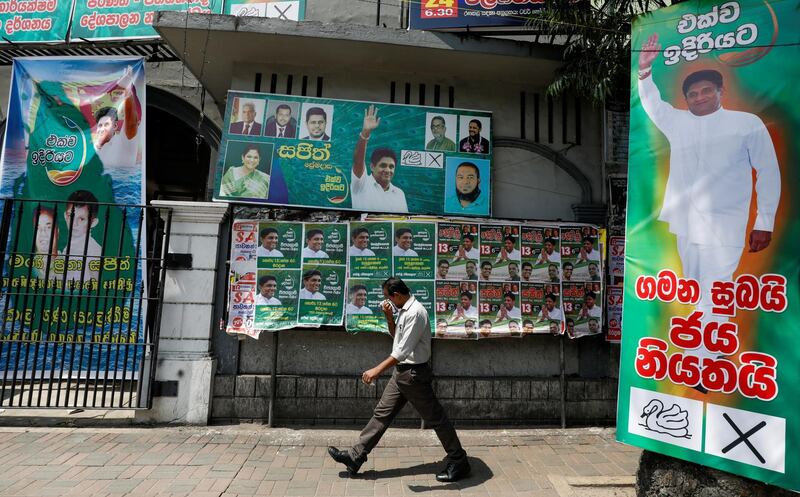 A man walks past the posters of Sajith Premadasa, Sri Lanka's presidential candidate of the New Democratic Front alliance, in Colombo, Sri Lanka November 13, 2019. REUTERS/Dinuka Liyanawatte