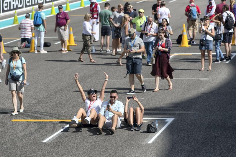 Abu Dhabi, United Arab Emirates, November 23, 2017:    Fans walk through pit lane during previews for the Abu Dhabi Formula One Grand Prix at Yas Marina Circuit in Abu Dhabi on November 23, 2017. Christopher Pike / The National

Reporter: John McAuley, Graham Caygill
Section: Sport