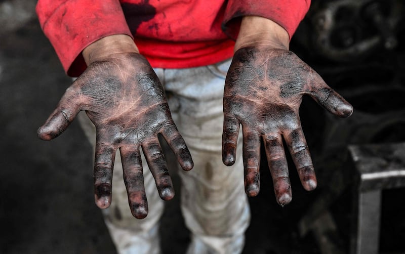 A young Syrian boy works at a car repair shop in the town of Jandaris, in the countryside of the north-western city of Afrin in the rebel-held part of Aleppo province, a day before the annual World Day Against Child Labour.