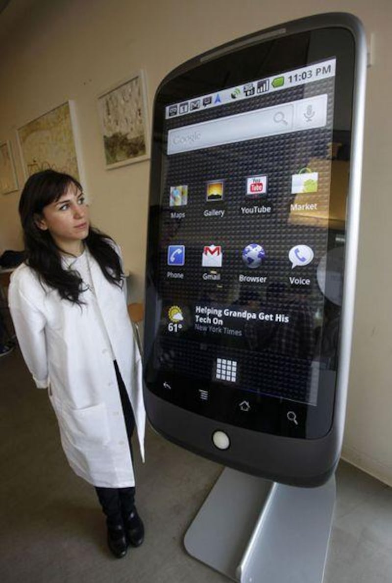 Google employee Sara Rowghani stands next to an enlarged model of the Nexus One phone at a demo in California.