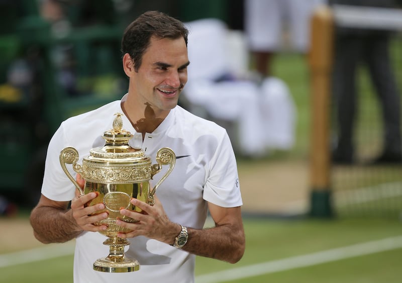 Switzerland's Roger Federer holds the trophy after defeating Croatia's Marin Cilic to win the Men's Singles final match on day thirteen at the Wimbledon Tennis Championships in London Sunday, July 16, 2017.. (AP Photo/Tim Ireland)