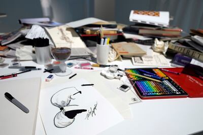 Lagerfeld sketched every design himself, and his cluttered desk was recreated for the exhibition.  AP