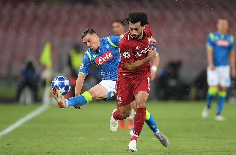 Napoli's Mario Rui tackles Liverpool's Mohamed Salah. Getty Images