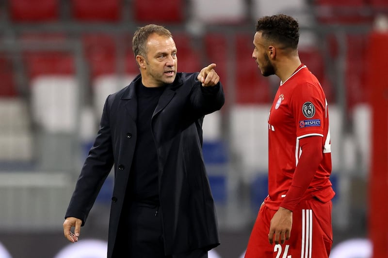 Hans-Dieter Flick, coach of Bayern, talks to Corentin Tolisso. Getty