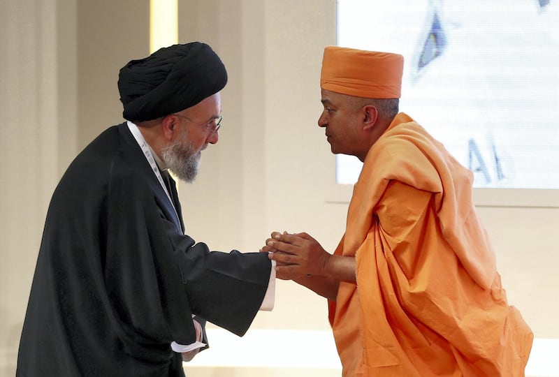 Abu Dhabi, United Arab Emirates - February 03, 2019: H.E. Swami Brahmavihari and H.E. Ali Al-Amin shake hands in the second session at the Global Conference of Human Fraternity. Sunday the 3rd of February 2019 at Emirates Palace, Abu Dhabi. Chris Whiteoak / The National
