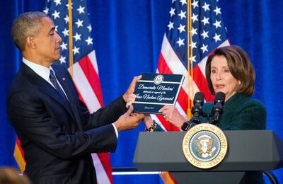 FILE - In this Jan. 28, 2016 file photo, President Barack Obama, left, is presented a copy of the Iran Nuclear Agreement Legislation by House Minority Leader Nancy Pelosi, in Baltimore, Md. President-elect Joe Biden has pledged to potentially return American to Iran's 2015 nuclear deal with world powers, which saw Tehran limit its enrichment of uranium in exchange for the lifting of economic sanctions. Trump unilaterally pulled out of the deal in 2018. (AP Photo/Pablo Martinez Monsivais, File)