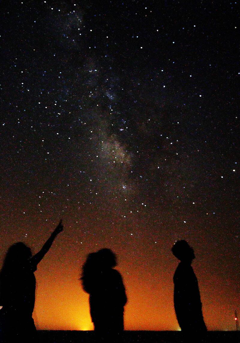 The Milky Way galaxy and various constellations are visible to the naked eye.