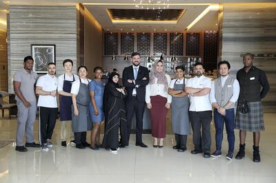 DUBAI , UNITED ARAB EMIRATES , January 17 ��� 2019 :- David Allan,  General manager (center) with his staff at The Radisson Blu hotel in Business Bay area in Dubai. The Radisson Blu Hotel Dubai Waterfront has banned its staff from calling guests Sir and Madam. (Pawan Singh / The National ) For News. Story by Gillian Duncan