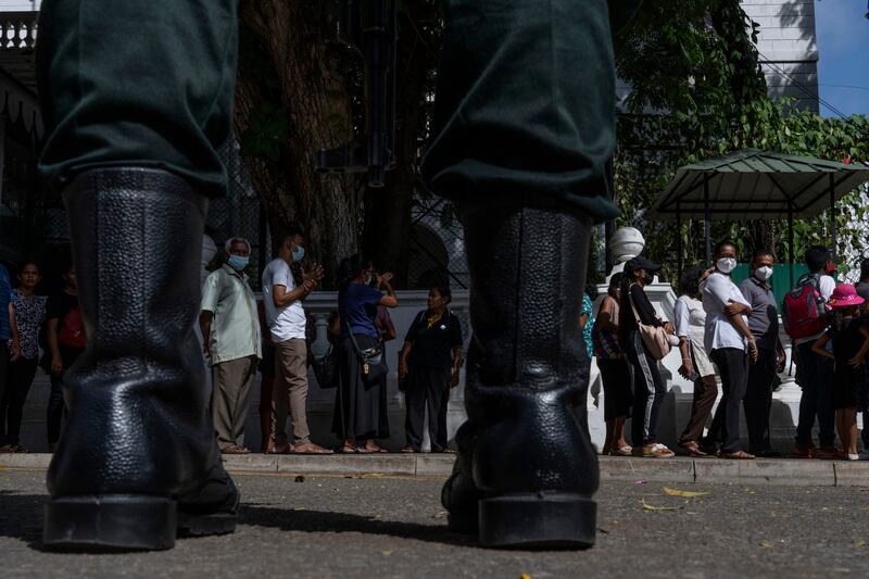 People wait to enter the presidential palace in Colombo, Sri Lanka. AP