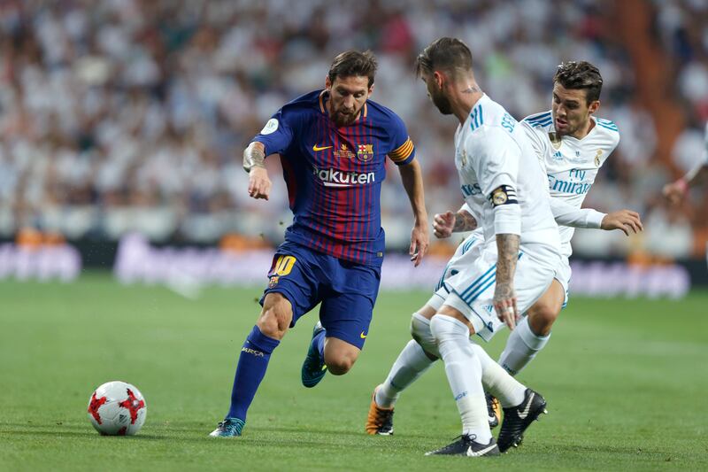 Barcelona's Lionel Messi, left, vies for the ball with Real Madrid defenders during the Spanish Super Cup second leg soccer match between Real Madrid and Barcelona at the Santiago Bernabeu Stadium in Madrid, Wednesday, Aug. 16, 2017. Real Madrid won 5-1 on aggregate. (AP Photo/Francisco Seco)