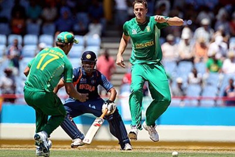 AB de Villiers of South Africa, left, attempts to run India's Suresh Raina out as Morne Morkel watches. Raina went on to score a century.