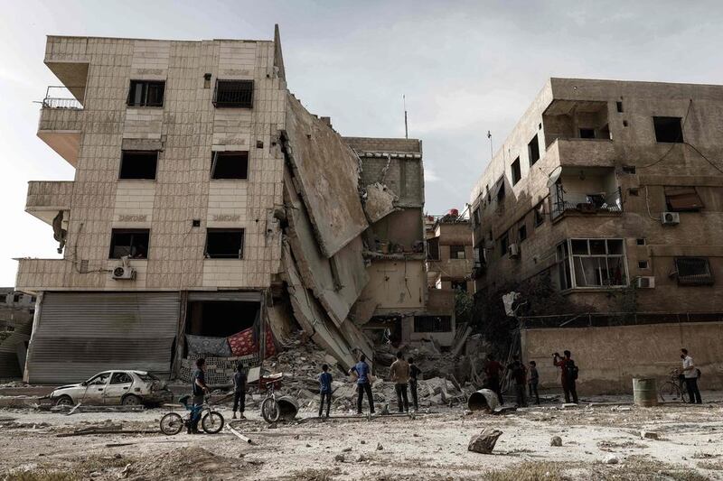 People inspect a hospital, damaged following an air strike a rebel-controlled town in the eastern Ghouta region on the outskirts of the capital Damascus, Syria. Sameer Al-Doumy / AFP