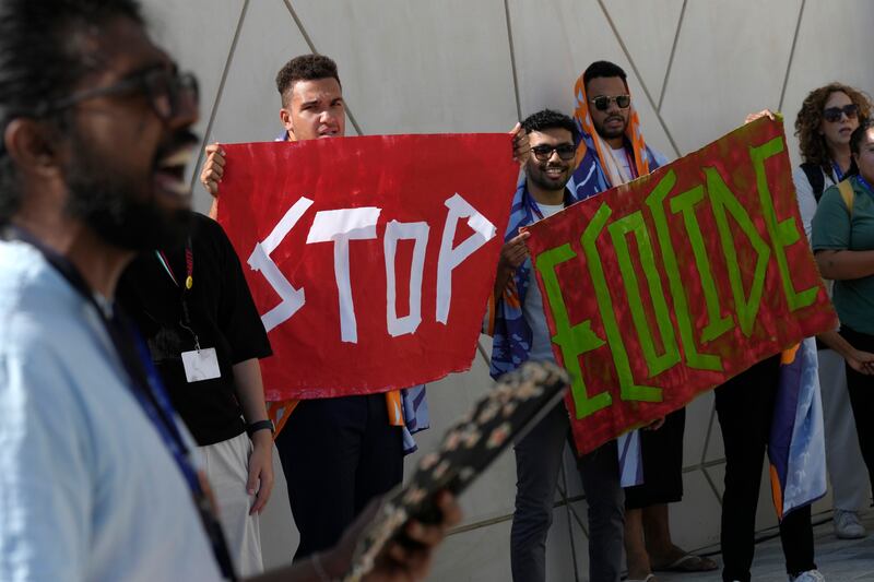 Demonstrators at the Cop28 UN climate summit in Dubai with their message to 'stop ecocide'. AP