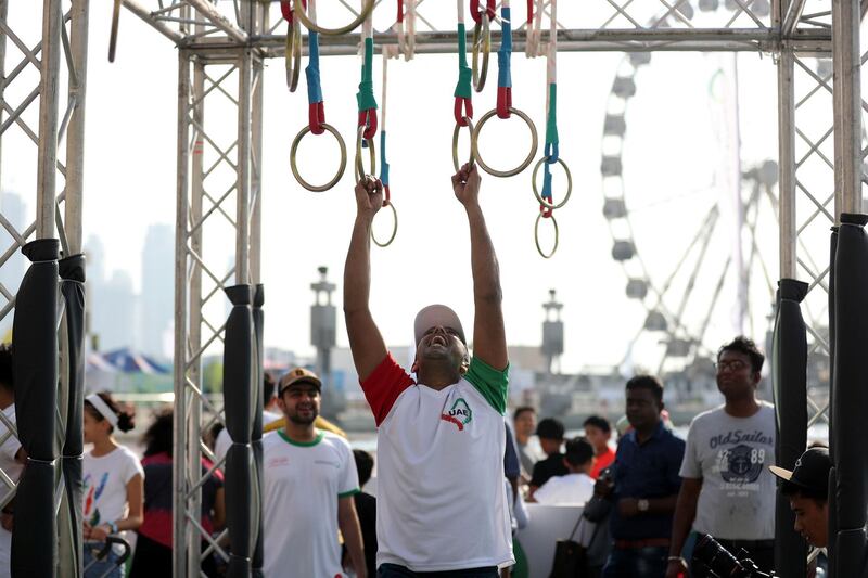 Dubai, United Arab Emirates - October 26, 2018:  People hang on the rings at Dubai Fitness Challenge. The Crown Prince of Dubai renews his emirate-wide call for every resident to take part in 30 minutes of exercise for 30 days. Friday, October 26th, 2018 Festival City Mall, Dubai. Chris Whiteoak / The National