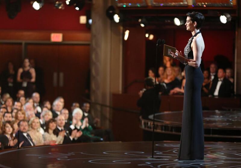 Anne Hathaway presents the award for best supporting actor. Matt Sayles / Invision / AP