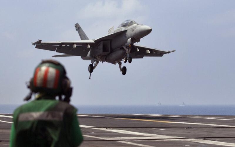 A US Navy fighter jet approaches to land on the aircraft carrier USS Theodore Roosevelt. Henry Kissinger has argued America needs to redefine its role in the Middle East. (AP Photo/Arun Sankar K.)