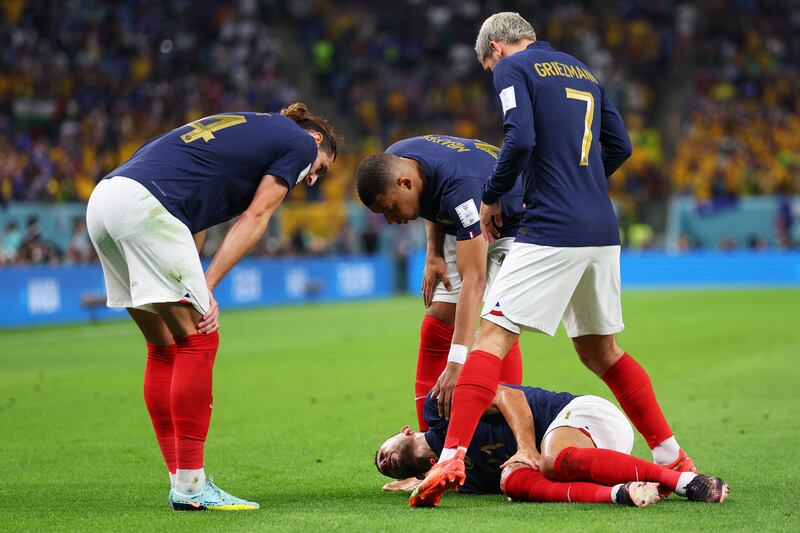 Lucas Hernandez of France is attended to by teammates after being injured. Getty