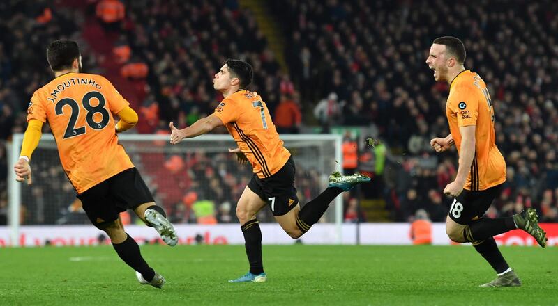Wolves midfielder Pedro Neto (C) celebrates with team-mates after putting the ball in the Liverpool net, a goal that was subsequently ruled out by VAR. AFP