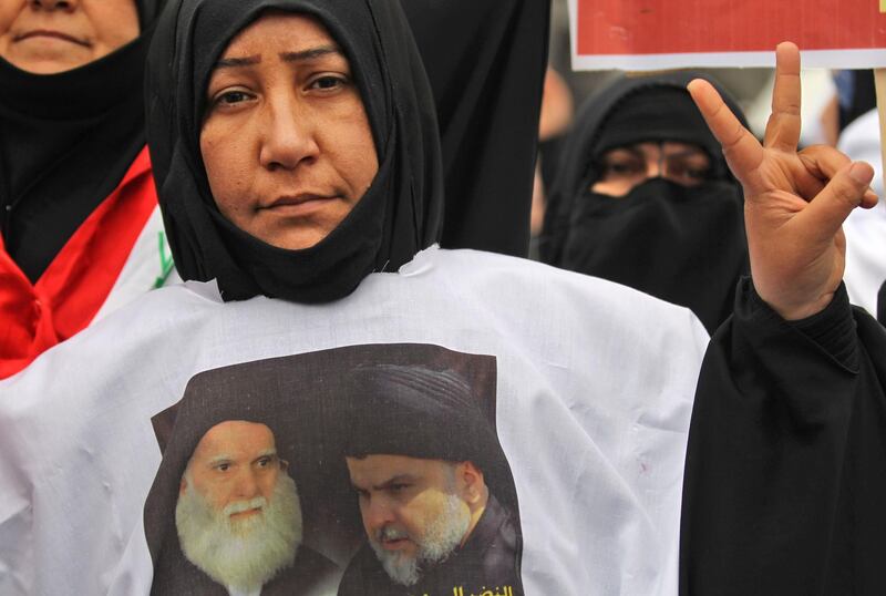 A woman wears a shirt with a photograph of Grand Ayatollah Mohammed Sadeq Al Sadr, a Shiite Muslim cleric assassinated during the late Iraqi president Saddam Hussein's rule, and Moqtada Al Sadr, as thousands gather in the capital Baghdad for a "million-strong" march to demand an end to the presence of US forces in their country. AFP