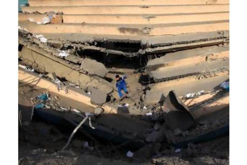A boy in the rubble of Gaza's Palestine Sports Stadium. Readers wonder if the truce will last. Mahmud Hams / AFP