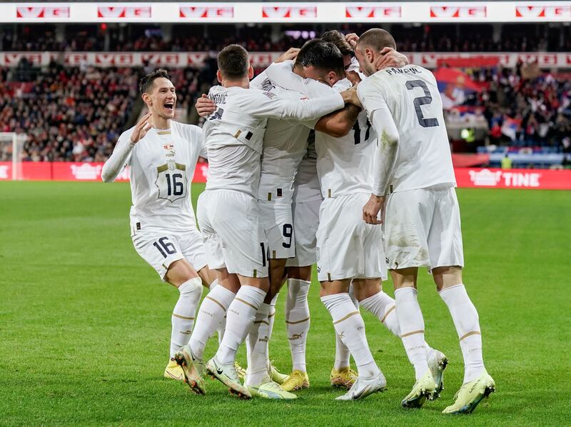 Dusan Vlahovic celebrates with teammates after scoring Serbia's first goal. Reuters