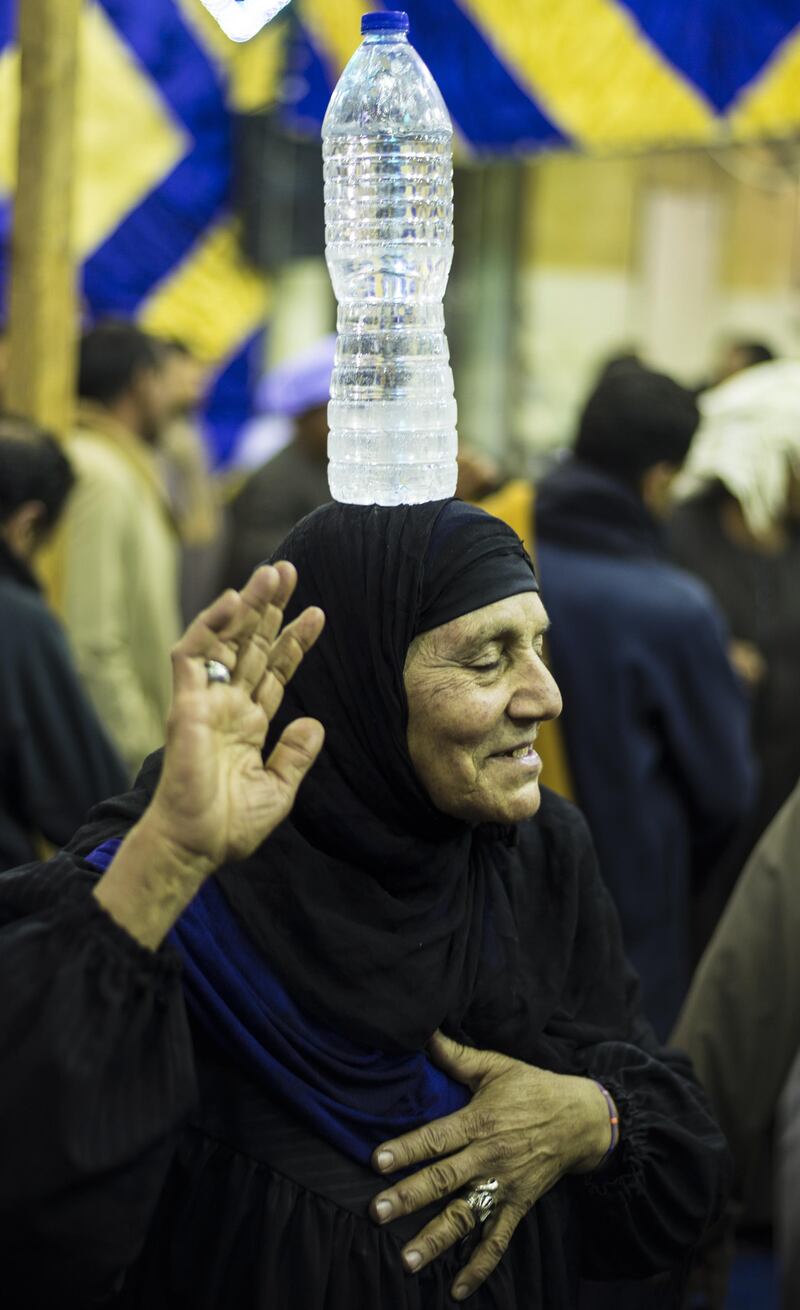 A woman celebrates at Cairo's Al-Hussein Mosque in Cairo, Egypt. Mawlid, meaning birthday in Arabic, is a celebration of a holy person. EPA