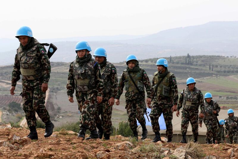 A picture taken from the southern Lebanese village of Meiss al-Jabal on December 16, 2018, shows United Nations Interim Forces in Lebanon (UNIFIL) soldiers patroling on the Lebanese side of the border with Israel.  Israel's army said it has uncovered another Hezbollah "attack tunnel" leading from Lebanon into its territory, the fourth since it started a search-and-destroy operation this month. / AFP / Mahmoud ZAYYAT
