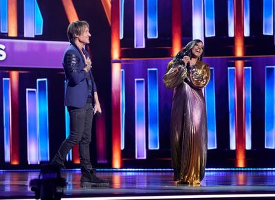 Hosts Keith Urban, left, and Mickey Guyton speak at the 56th annual Academy of Country Music Awards on Sunday, April 18, 2021, at the Grand Ole Opry in Nashville, Tenn. (AP Photo/Mark Humphrey)