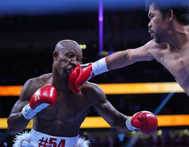 Manny Pacquiao lands a punch on Yordenis Ugas. Reuters