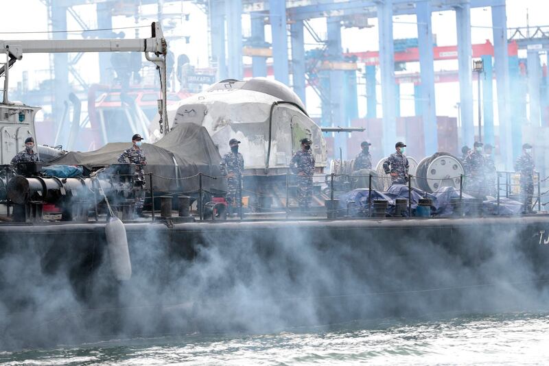 Sailors of an Indonesian Navy ship stand on the deck as they depart for a rescue operation for a Sriwijaya Air passenger jet that crashed off Java island, at Tanjung Priok Port in Jakarta, Indonesia. Indonesian rescuers pulled out body parts, pieces of clothing and scraps of metal from the Java Sea early Sunday morning, a day after a Boeing 737-500 with dozens of people on board crashed shortly after takeoff from Jakarta, officials said. AP Photo