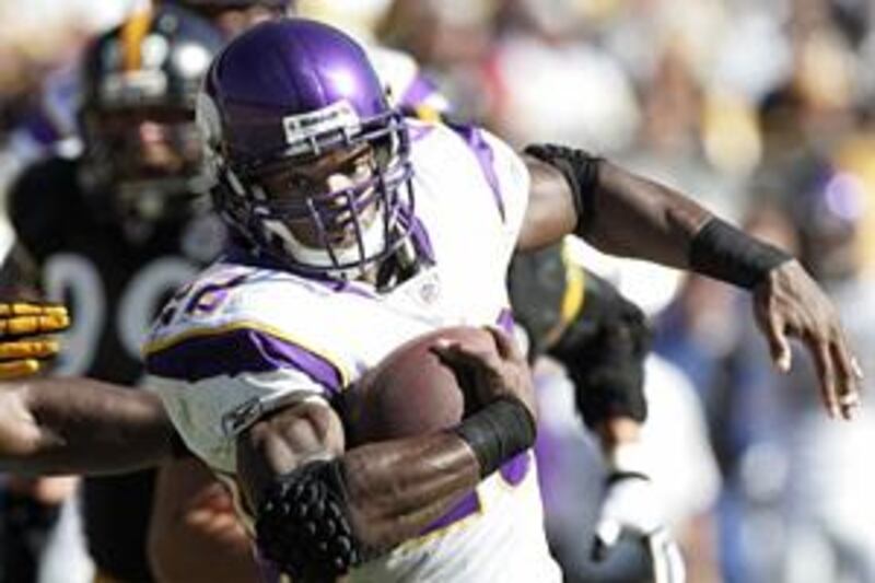 The Vikings' Adrian Peterson eludes the Steelers' Lawrence Timmons in NFL action on Sunday.