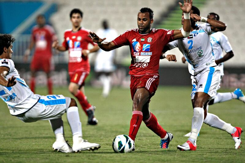 DUBAI, UNITED ARAB EMIRATES - October 9, 2012- Baniyas's Luiz Fernando Da Silva © keeps the ball from Baniyas players Fahad Sabil Obeid ¨ and Mohamed Jaber (L) during second half football action in Baniyas Stadium in Baniyas, Abu Dhabi October, 9, 2012. Al Jazira defeated Baniyas 3-2. (Photo by Jeff Topping/The National)