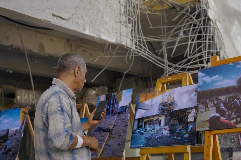 A person looks at images depicting last week's attack at Aden airport, upon the arrival of UN Special Envoy for Yemen Martin Griffiths in Aden, Yemen. EPA