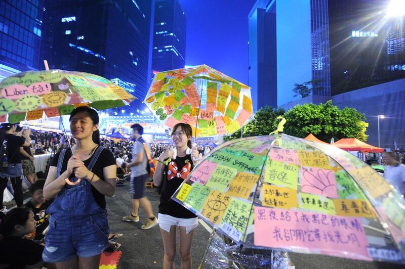 Pro-democracy protesters put up their umbrellas near the government headquarters in Hong Kong on October 2, 2014. On July 22, 2016, three student leaders who were at the forefront of what has now been termed the “Umbrella Movement”, were convicted of participating in and inciting others to join the protests. The Yomiuri Shimbun via AP Images