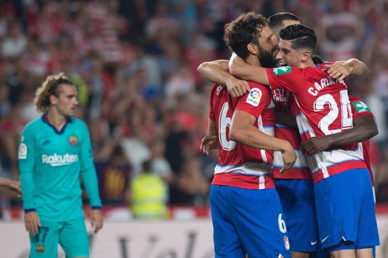 Granada players celebrate their win at the end of the La Liga match against Barcelona. Granada won 2-0 at Nuevo Los Carmenes Stadium to go top of the table. AFP
