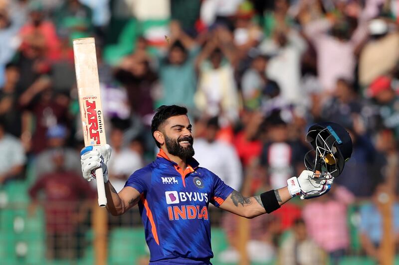 India's Virat Kohli raises his bat to celebrate his century. AP