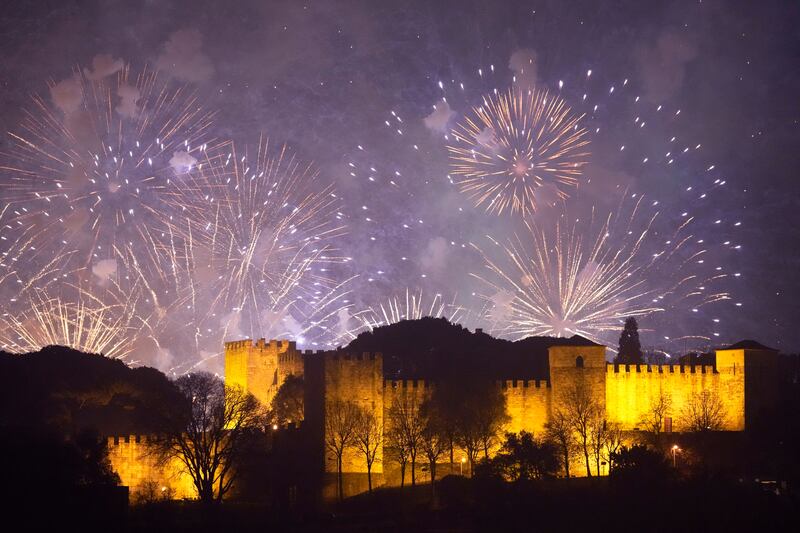 Fireworks mark the new year behind Saint Georges Castle in Lisbon. AP Photo
