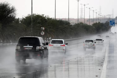 Vehicles kick up spray as rain falls on the Dubai – Al Ain road in Al Ain. Pawan Singh / The National