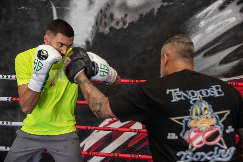 Hamzah Sheeraz hits the pads with trainer Ricky Funez at the Real Boxing Only Gym. Antonie Robertson / The National