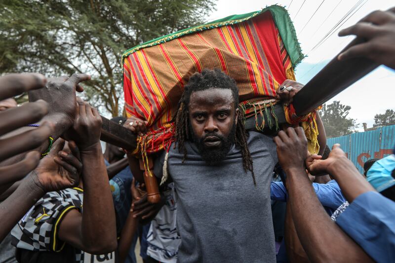 Friends and relatives carry the casket of 19-year-old Ibrahim Kamau in Nairobi, Kenya. EPA
