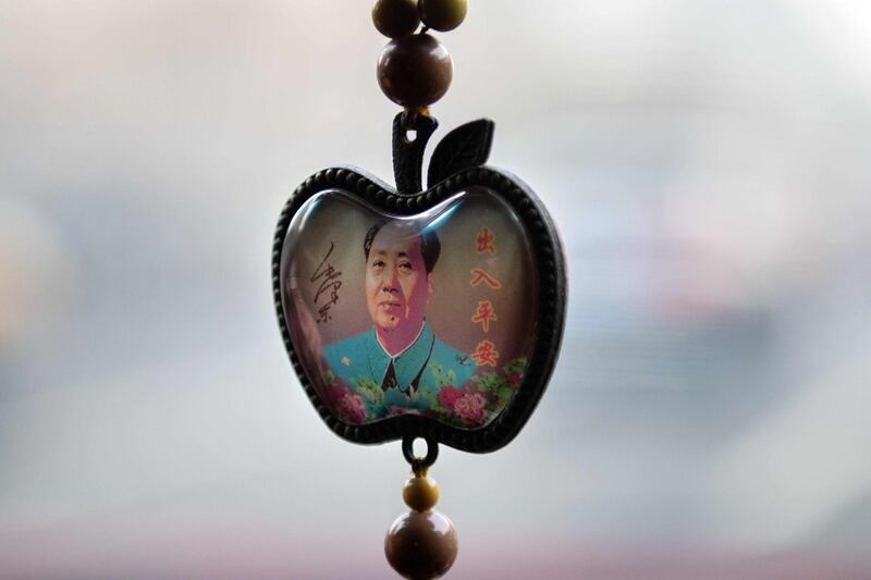 A portrait of late Chinese communist leader Mao Zedong hangs in an apple-shaped pendant in Beijing, China. AFP