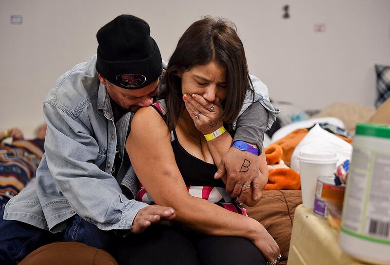 Joseph Grado and his wife, Susan Grado, hug one another while staying at a shelter for fire victims at East Avenue Church in Chico. AP Photo