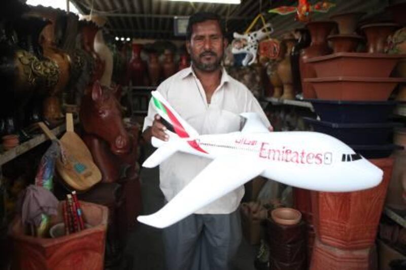 United Arab emirates - Fujarah - October 26th, 2010: Abdul Salam of Rashid al Abduoli Potter holding an inflatable Emirates airplane.  10 dirhams.  (Galen Clarke/The National)  ISTABSIR