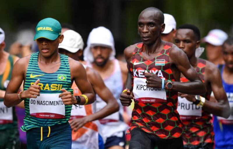 Daniel Do Nascimento of Brazil, left, and Eliud Kipchoge of Kenya during the men's marathon at Sapporo Odori Park.