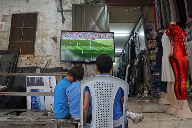 Palestinian children watch the World Cup 2022 Asian qualifying match between Palestine and Saudi Arabia in the northern Israeli occupied West Bank city of Nablus. AFP