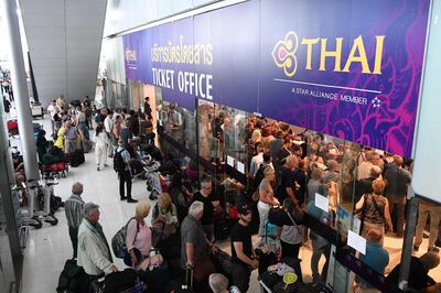 Stranded passengers wait the Thai Airways ticket counter at the Suvarnabhumi International Airport in Bangkok on February 28, 2019. Thai airways cancelled 11 European-bound flights after Pakistan closed its airspace as tensions with India mount, the carrier said February 28, a move affecting thousands of passengers at the height of the country's busy tourist season. / AFP / Lillian SUWANRUMPHA
