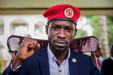 Opposition presidential challenger Bobi Wine, whose real name is Kyagulanyi Ssentamu, gestures as he speaks to the media outside his house after government soldiers withdrew from it, in Magere, near Kampala. AP