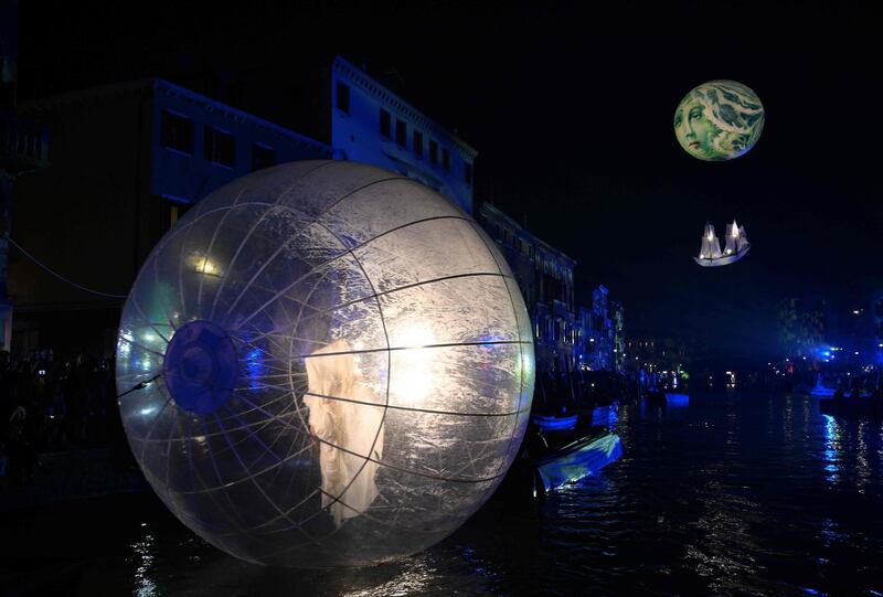 Artists perform during the 'Tutta colpa della Luna' or 'Blame the Moon' festivities down the Rio di Cannaregio, one of Venice's famed canals on February 16, 2019.  Venice began its annual Carnival festivities with a floating, night-time parade starting more than two weeks of celebrations to mark 50 years since man first walked on the moon. / AFP / Vincenzo PINTO
