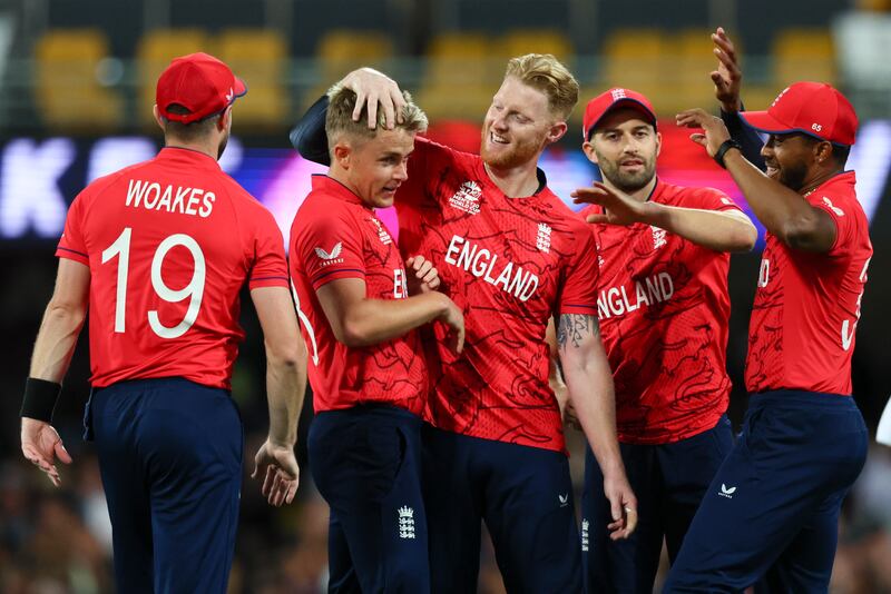 Sam Curran, second left, is congratulated by teammates after taking the wicket of New Zealand's Glenn Phillips during the T20 World Cup match in Brisbane, Australia on Tuesday, November  1, 2022.  AP